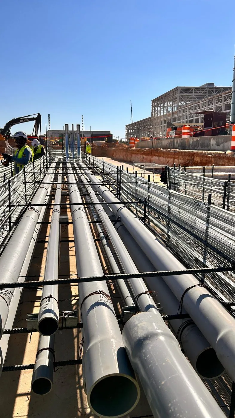 Electrical conduit arranged within reinforced concrete framing