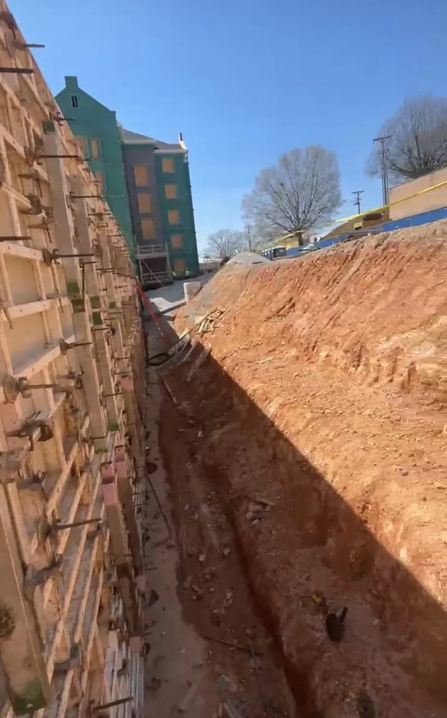 Excavation and wall formwork at an active construction site